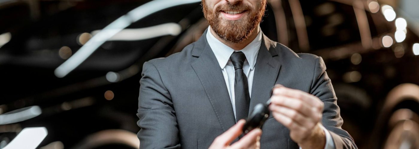 salesman-with-key-at-the-car-dealership.jpg